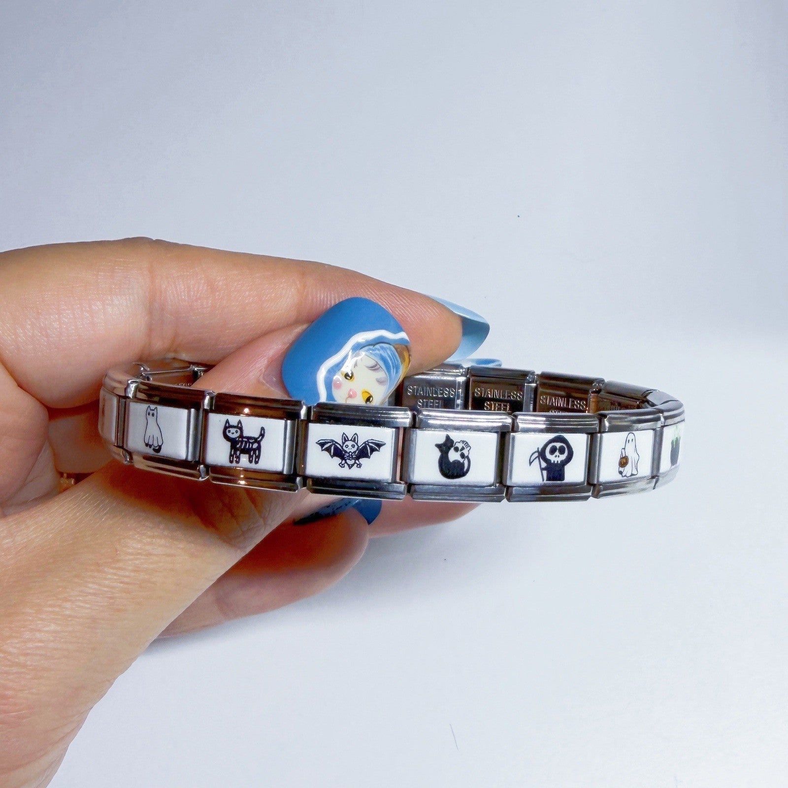 Hand holding a Pami Charms bracelet featuring various designs, perfect for a stylish italian charm collection