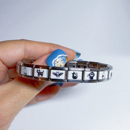 Hand holding a Pami Charms bracelet featuring various designs, perfect for a stylish italian charm collection