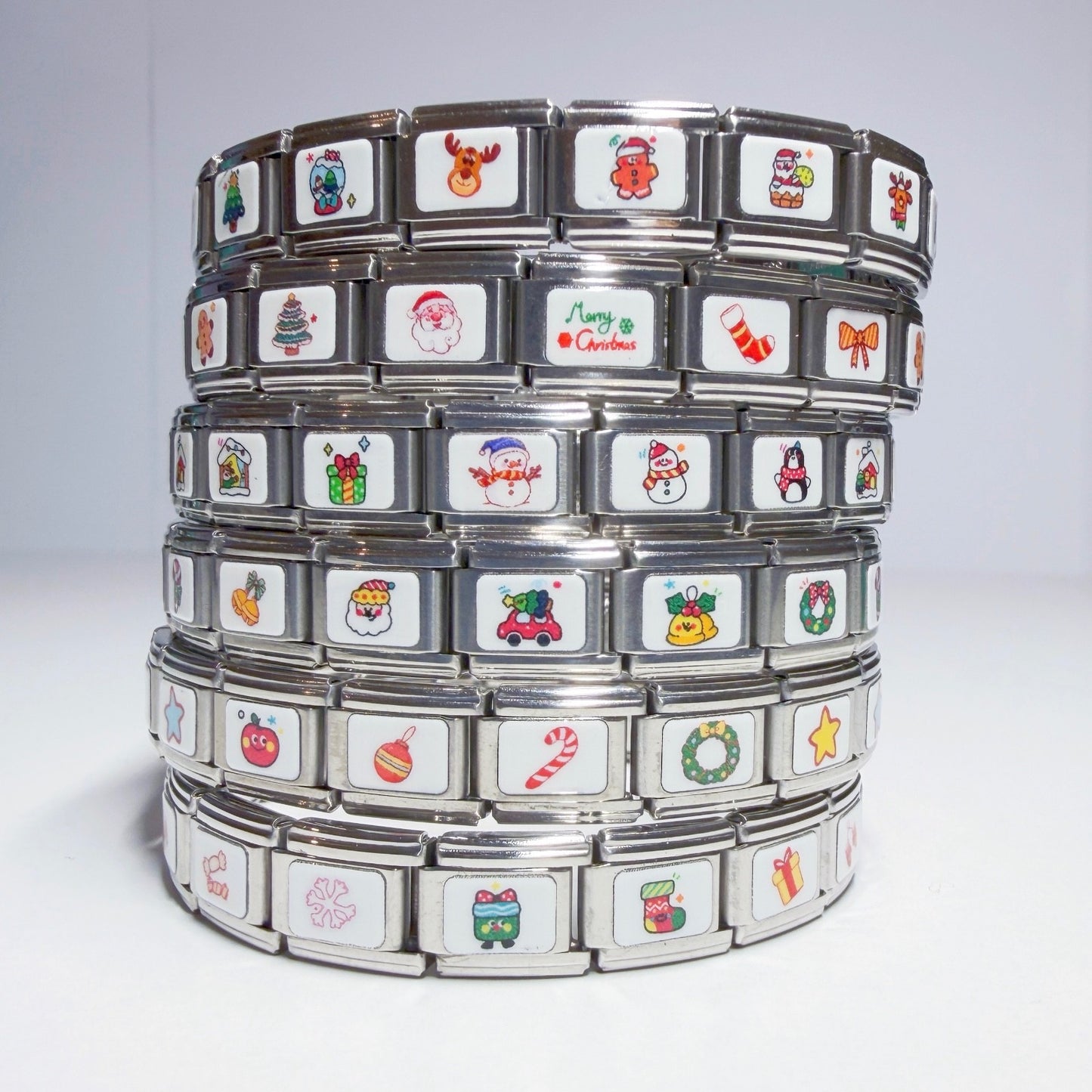 Stack of Pami Charms featuring festive designs in Italian charm style for personalised bracelets