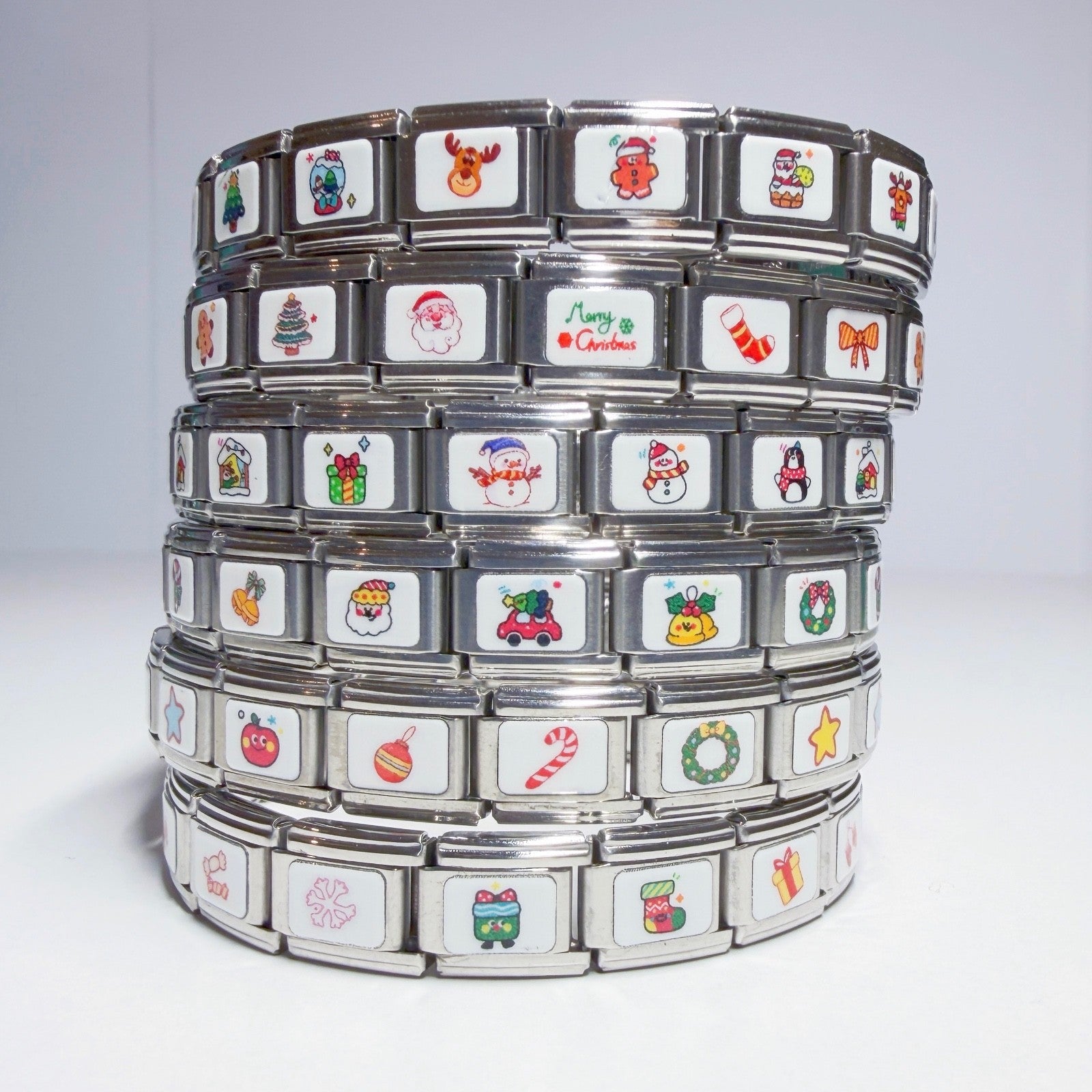 Stack of Pami Charms featuring festive designs in Italian charm style for personalised bracelets