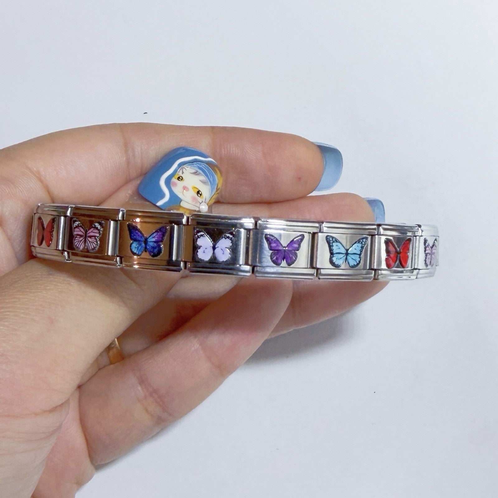 Pami Charms Italian charm bracelet featuring colourful butterfly designs on silver links