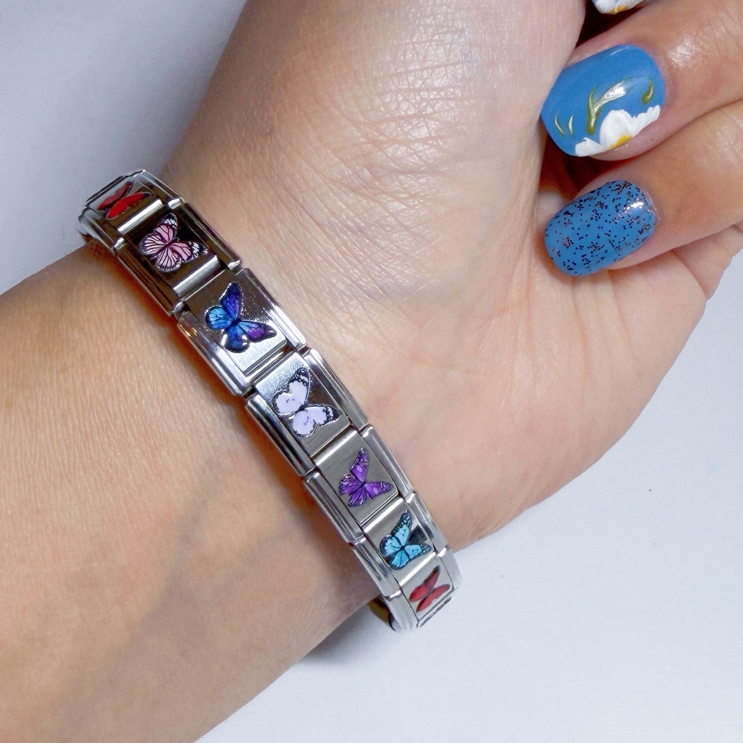Pami Charms Italian charm bracelet featuring colourful butterfly designs on a silver band