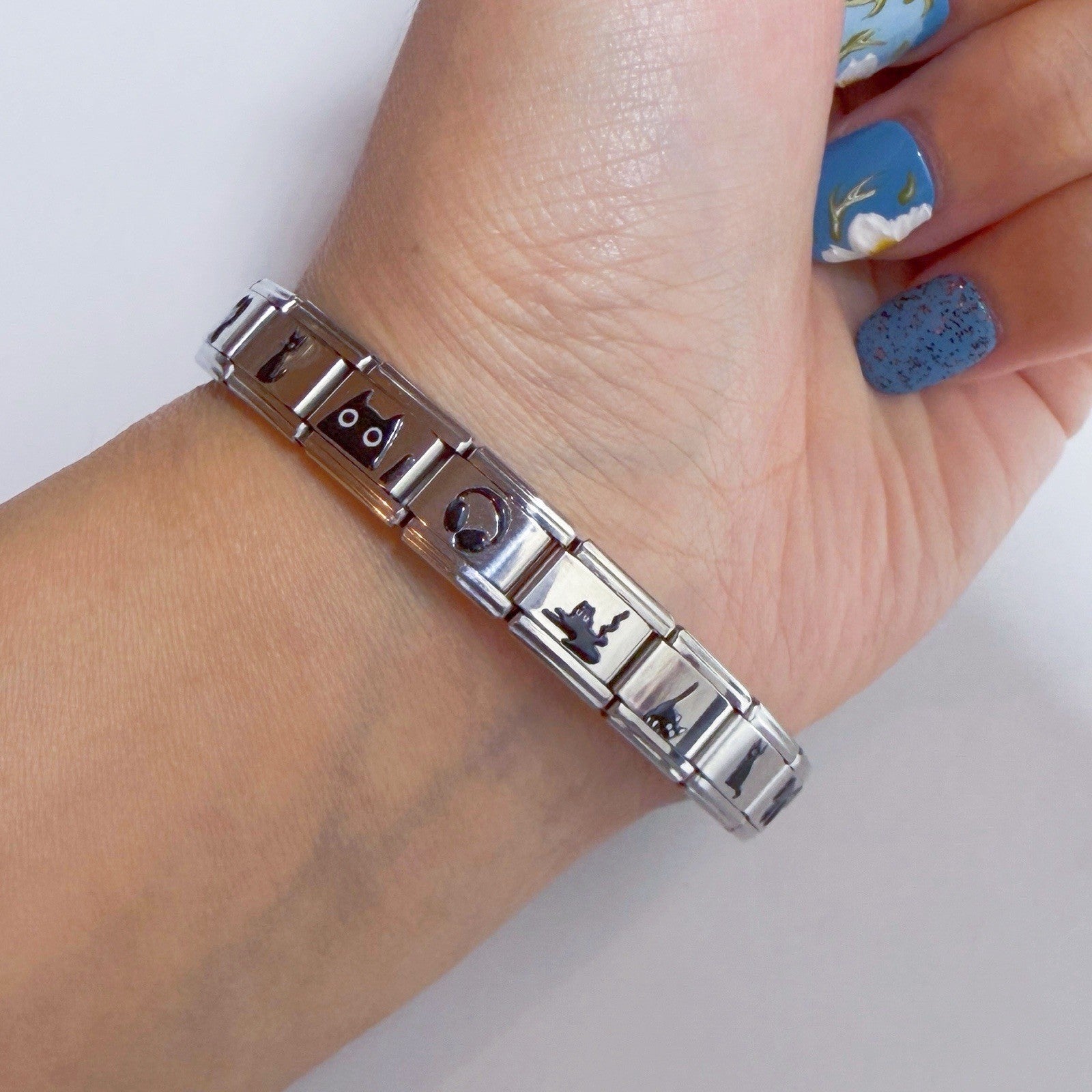 Elegant Italian charm bracelet featuring various unique designs on a silver band