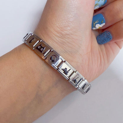 Elegant Italian charm bracelet featuring various unique designs on a silver band