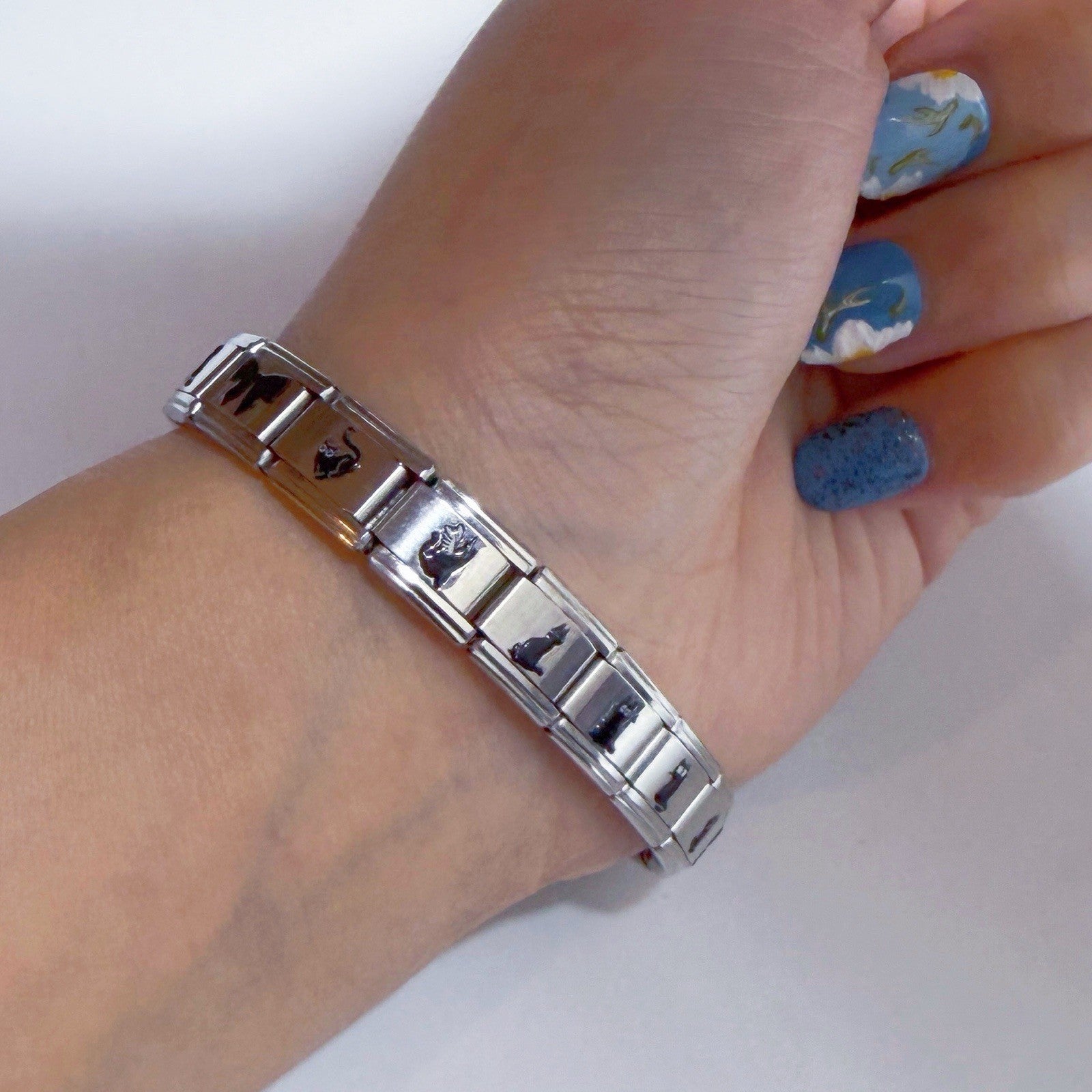 Pami Charms Italian charm bracelet featuring various unique designs on a silver metal band