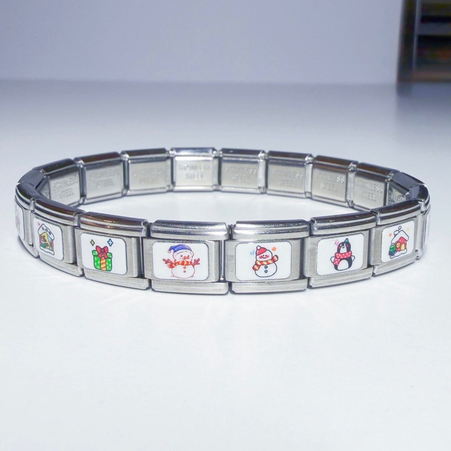 Pami Charms Italian charm bracelet featuring festive winter designs like snowmen and gifts
