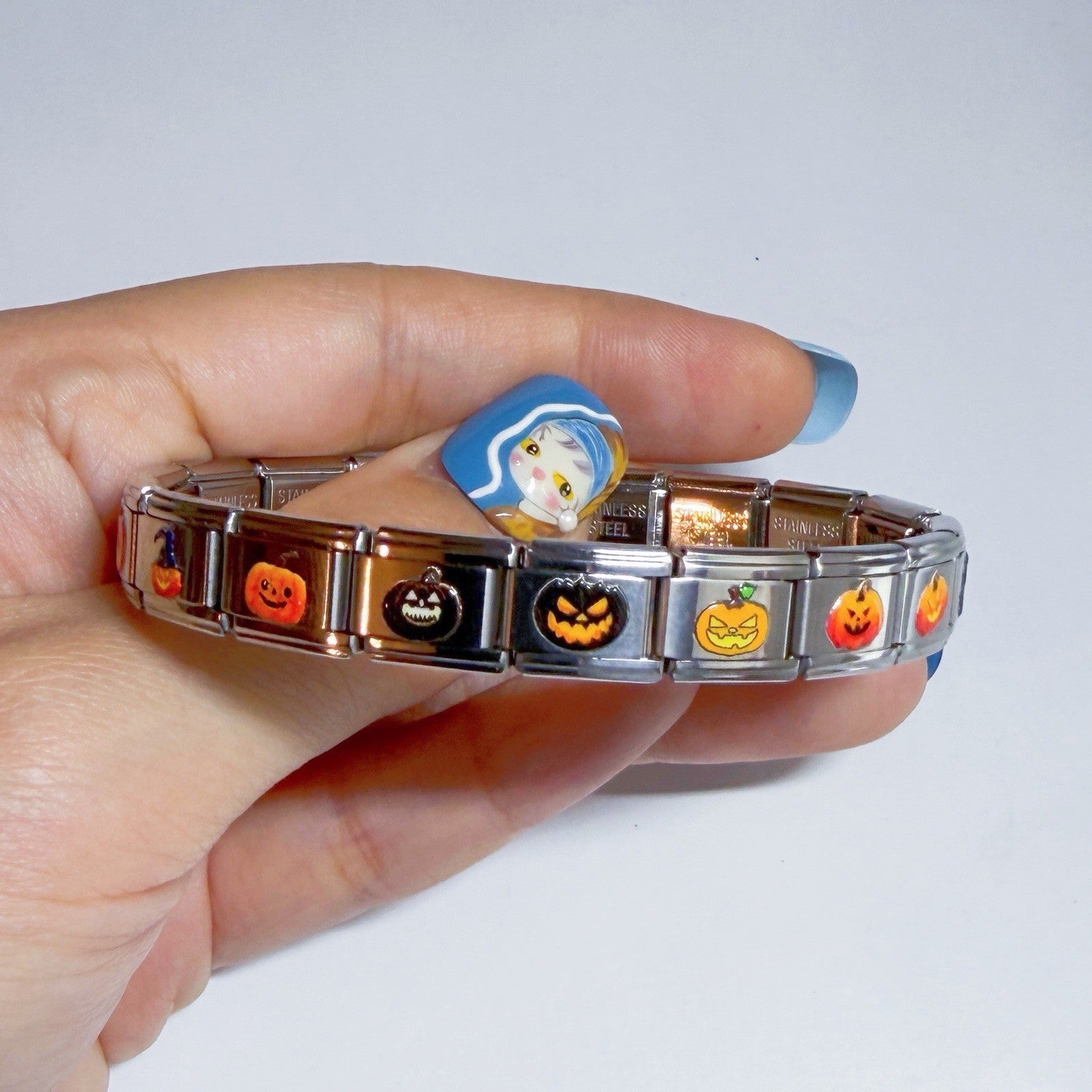 Stainless steel bracelet featuring colourful Halloween themed italian charms on a hand