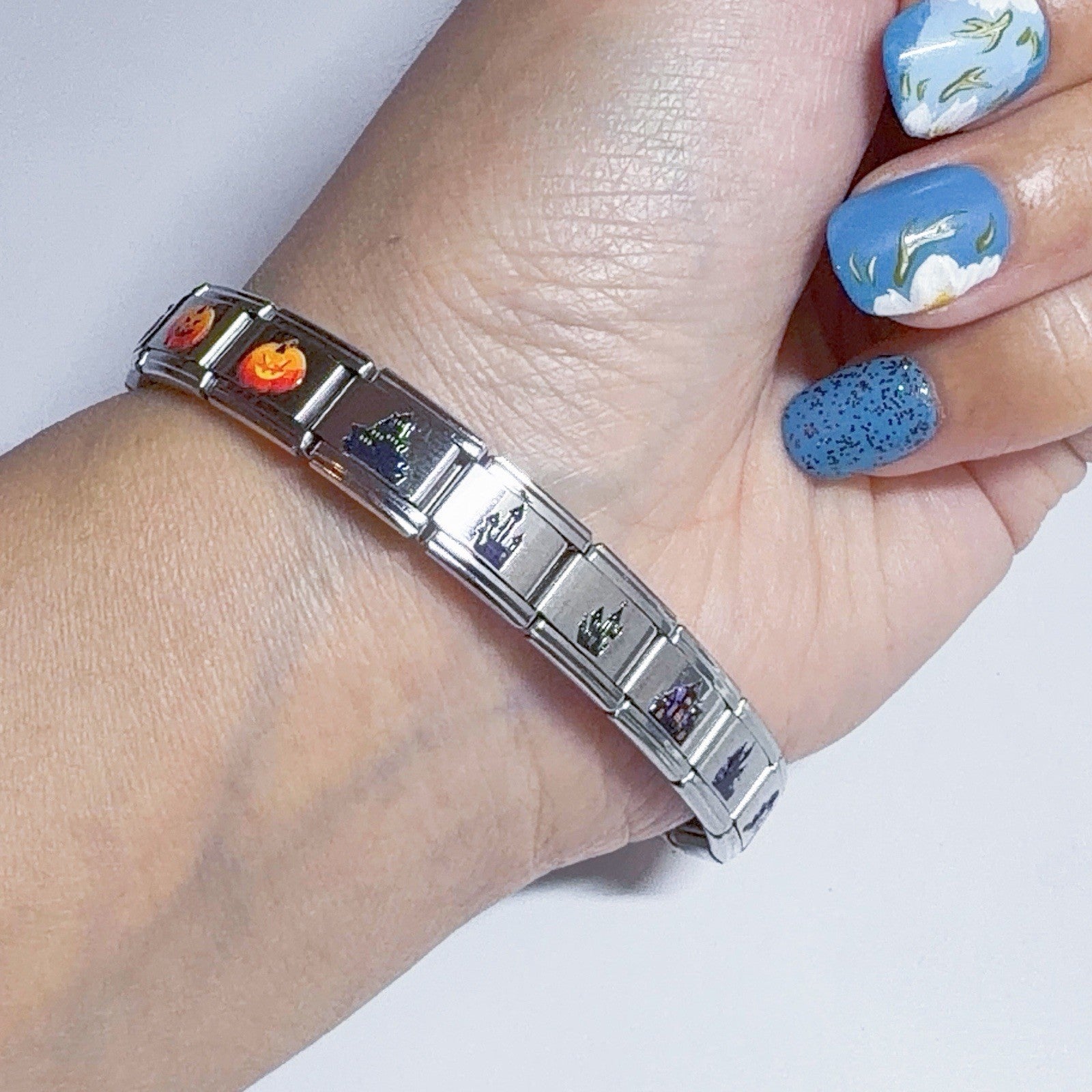 Stylish silver bracelet adorned with vibrant Italian charms featuring various designs