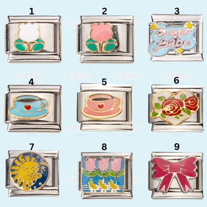 Set of nine Pami Charms italian charms including flowers, teacups, Sugar Babe text, rose heart, sun, tulips, and pink bow designs