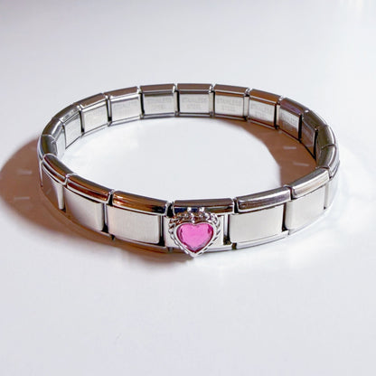 Pami Charms Italian charm bracelet featuring a silver design and a pink heart detail