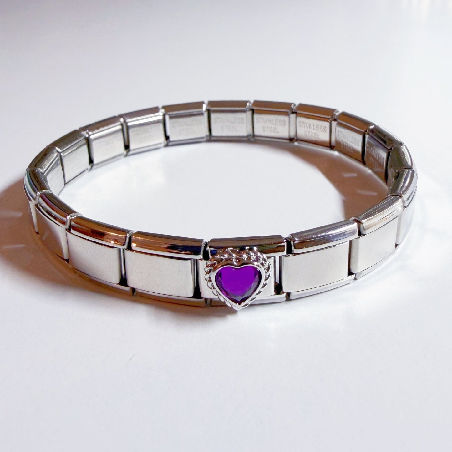 Pami Charms Italian charm bracelet featuring a heart-shaped purple embellishment