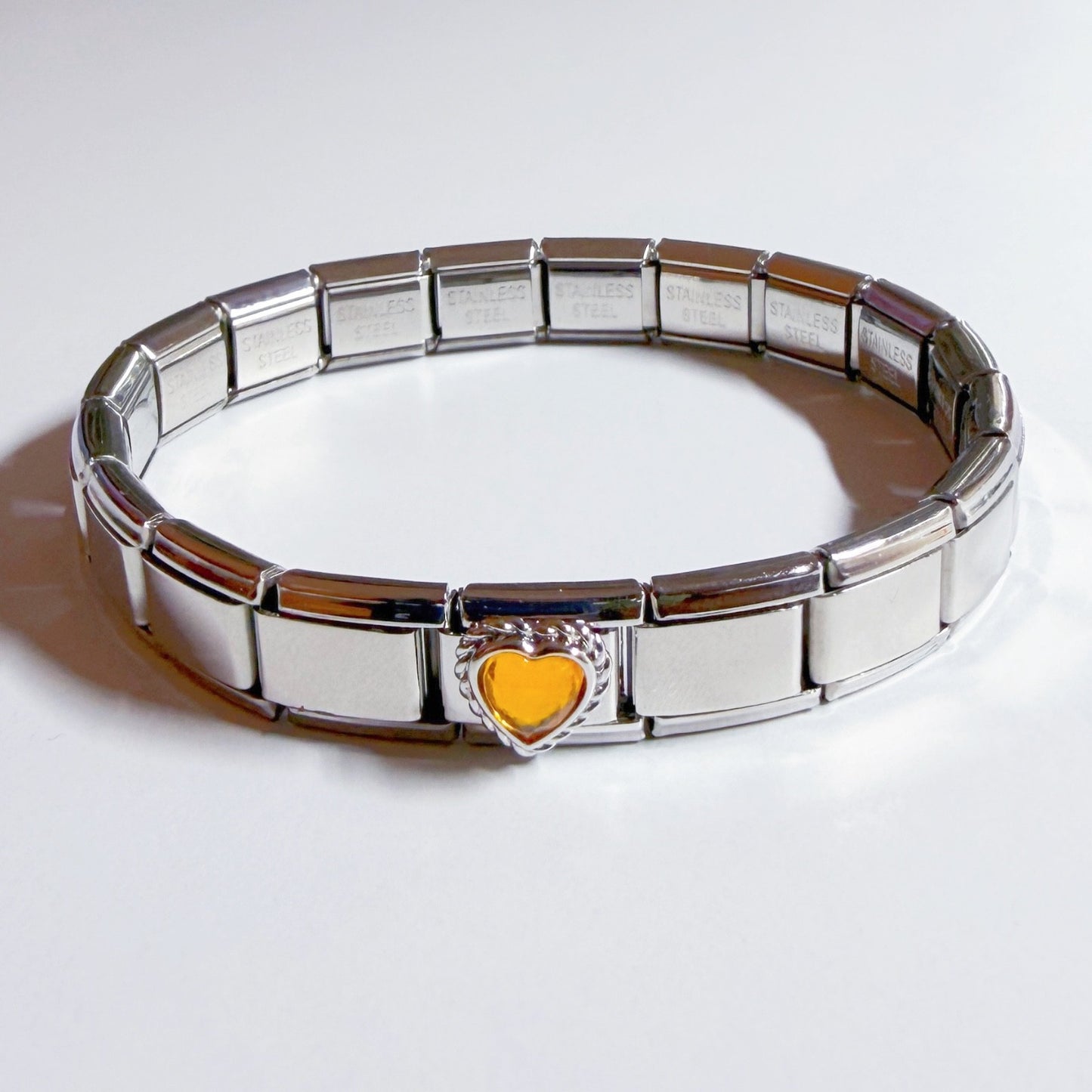 Silver Italian charm bracelet featuring a yellow heart charm for a stylish accessory